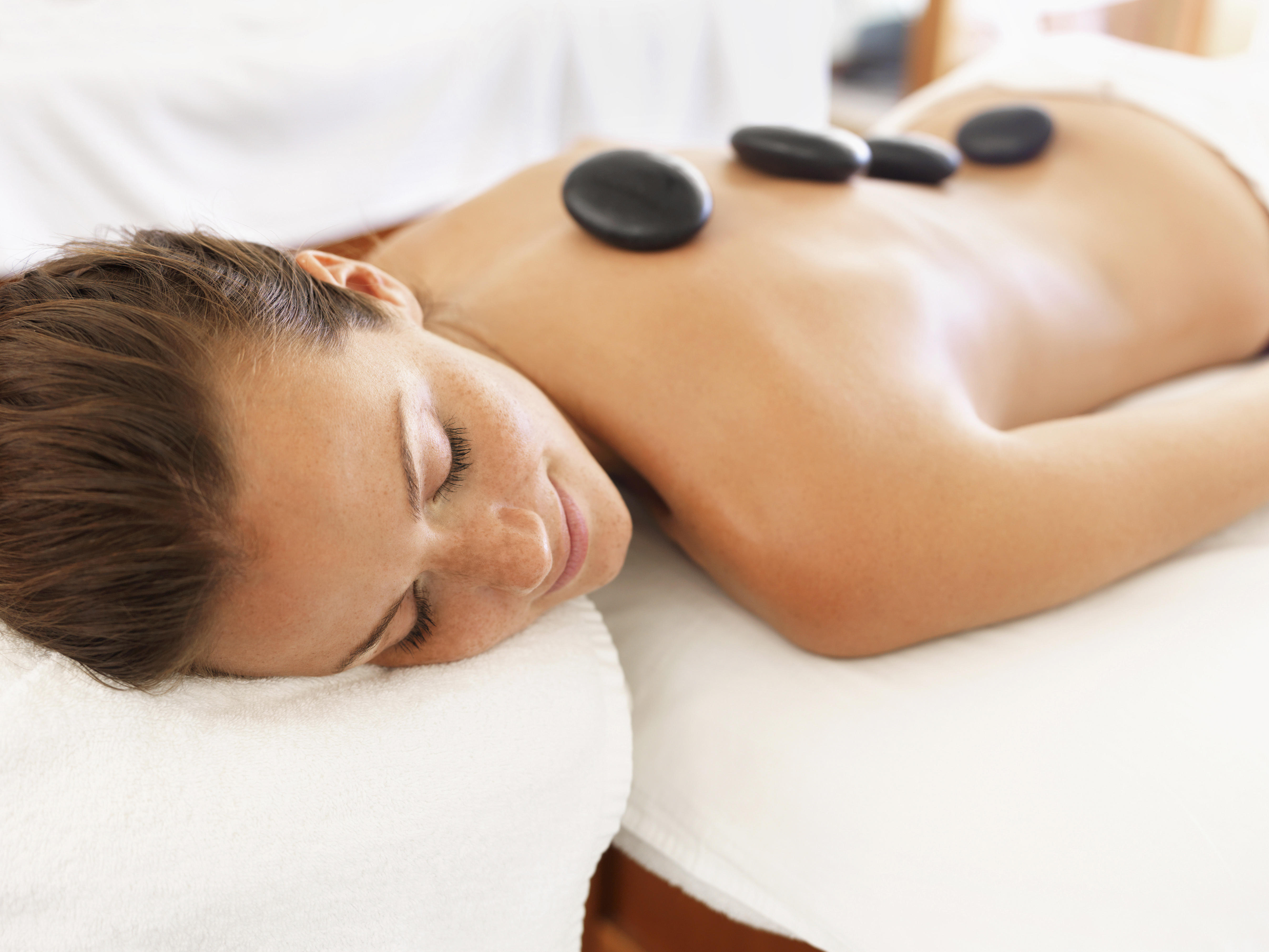 Hot stone massage treatment at Vibrant Living Day Spa